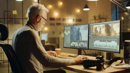 Poster - Evening in Creative Office: Professional Middle Aged Videographer Works on Desktop Computer, Doing Footage Montage, Using Video Editing Software. Modern Video Developers Office