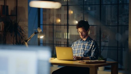 Aufkleber - Handsome Male Creative Office Employee Sitting at His Desk Works on the Laptop