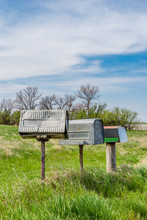 A Row Of Three Old Metal Farmer’s Mailboxes On The Prairies In Rural Saskatchewan, Canada