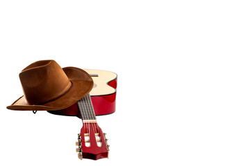 Fototapete - American culture, folk song and country muisc concept theme with a cowboy hat and an acoustic guitar isolated on white background with a clip path cut out and copy space