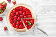 Delicious strawberry tart on white wooden background, top view
