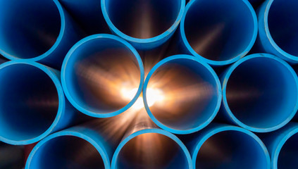 group of blue water pipes that is stacked into a graphic format with light coming from behind