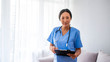 © Dragana Gordic - Woman healthcare worker with clipboard. Portrait of confident young Asian female doctor. Doctor with stethoscope around his neck looking at the camera