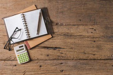 Wall Mural - Top view Pen, notebook, glasses, calculator,  smartphone on the wooden table and copy space