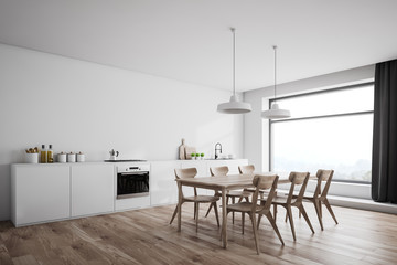 White kitchen corner with wooden table