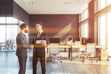 Canvas Print - Businessmen shaking hands in gray office