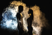 The Silhouette Of Man And Woman In The Smoke