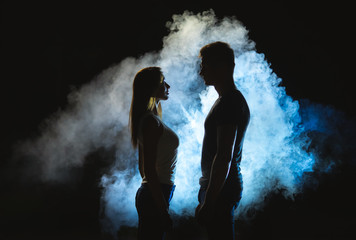 The silhouette of man and woman in the smoke