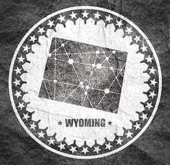 Wall Mural - Image relative to USA travel. Wyoming state map textured by lines and dots pattern. Stamp in the shape of a circle