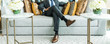 © kowitstockphoto - richness and success concept. business man sitting on a leather couch, putting his foot on the leg