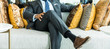© kowitstockphoto - richness and success concept. business man sitting on a leather couch, putting his foot on the leg