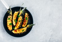 Grilled Pineapple With Fresh Mint In Cast Iron Pan On Gray Stone Background.