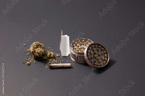 weed, joint, paper and grinder on black Poster Mural XXL