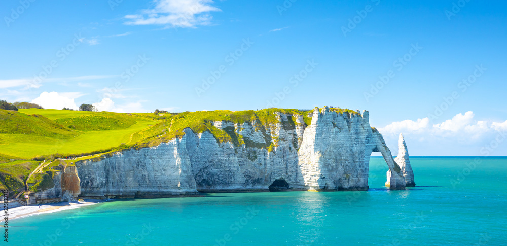 Coastal landscape along the Falaise d'Aval the famous white cliffs of Etretat village with the Porte d'Aval natural arch and the rock known as the Aiguille d'Etretat. France - obrazy, fototapety, plakaty 