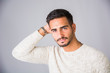 © theartofphoto - Handsome young man wearing white sweater, on light background in studio shot