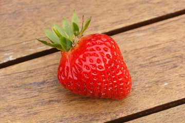 Wall Mural - Strawberry on a wooden table after harvesting during summer