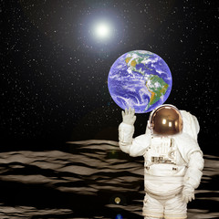 Wall Mural - Astronaut on the moon. Blue fascinating earth on the background. Elements of this image furnished by NASA.
