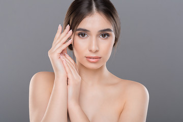 Wall Mural - Young woman applying moisturizing cream to her hands skin