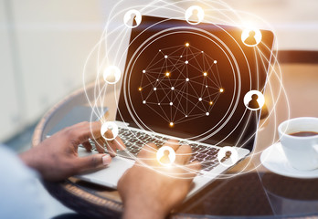 Leinwandbilder - Social network hologram with businessman working on laptop