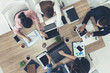 © InfiniteFlow - Top view of businessman executive in group meeting with other businessmen and businesswomen in modern office with laptop computer, coffee and document on table. People corporate business team concept.