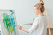 © alfa27 - young attractive awesome girl concentrated on painting. process of creation a wonderful masterpiece. close up side view photo