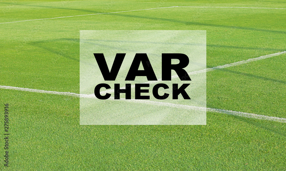 VAR CHECK text on empty football soccer field with white marks