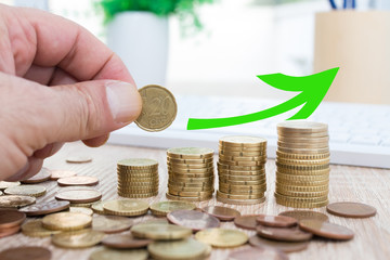 hand with coin and money stacked