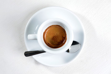 Cup of coffee (espresso) with spoon on white background