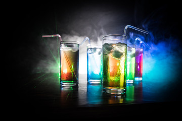 collection of colorful shots with lemon on bar; set of alcohol mini cocktail shooters with lime;