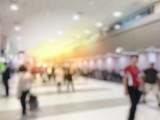 Fototapeta Zachód słońca - Blurred image abstract background of people or passenger walking in or hurry up in airport transport  terminal and lounge interior from airplanes are walking to the immigration gates.