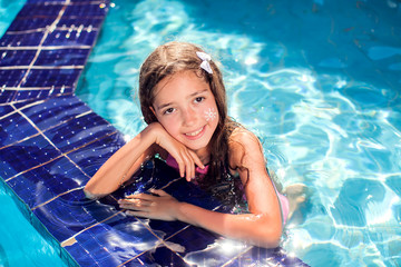 Wall Mural - Kid girl with sun protection cream on her skin in the pool. Children, summer, holiday and healthcare concept