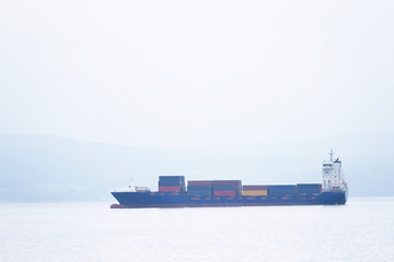 Wall Mural - Cargo ship vessel freight containers carrier transport on sea ocean to port dock