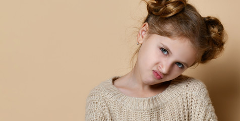 Naughty little girl over the beige background