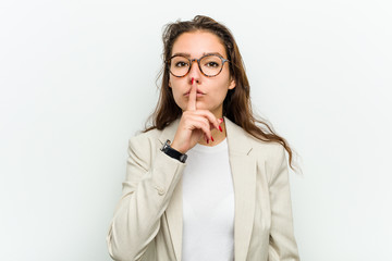 Wall Mural - Young european business woman keeping a secret or asking for silence.