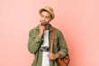 © Asier - Young filipino traveler man looking sideways with doubtful and skeptical expression.