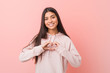 © Asier - Young pretty arab woman wearing a casual sport look smiling and showing a heart shape with hands.