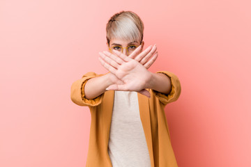 Young caucasian woman wearing a casual business clothes doing a denial gesture