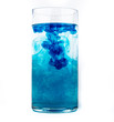 Blue food coloring diffuse in water inside glass with empty copyspace area for slogan or advertising text message, over isolated white background.
