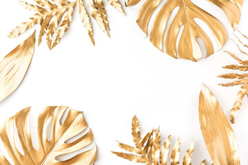 Flat lay of golden tropical leaf design elements. Decoration elements for invitation, wedding cards, valentines day, greeting cards. isolated over white background. Top view