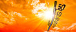 Hot summer or heat wave background, glowing sun on orange sky with thermometer