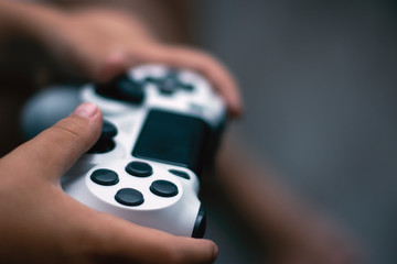 Poster - Joystick in game. Close-up of hands holding gamepad. Games concept.