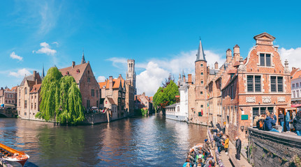 Panoramic city view with Belfry tower and famous canal in Bruges, Belgium.