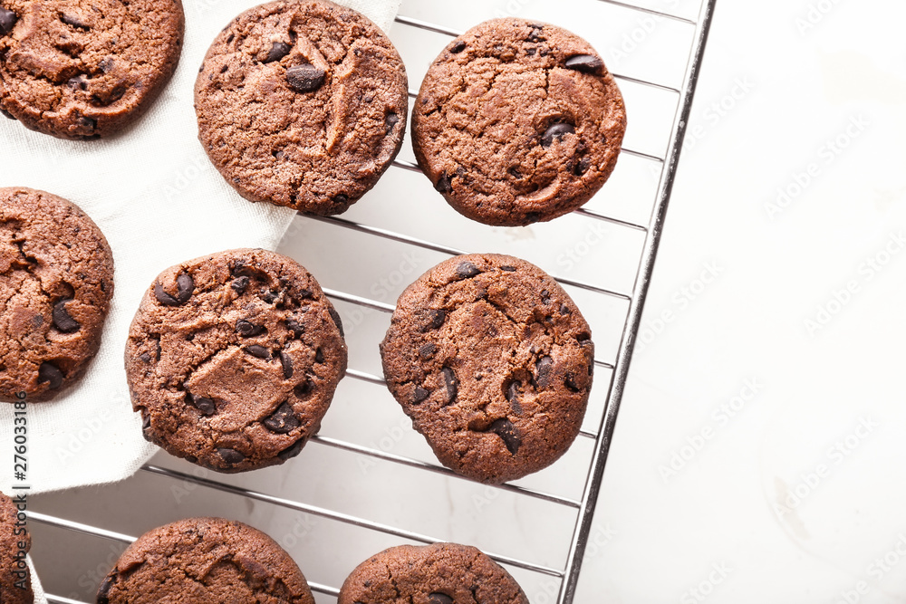 Tasty chocolate cookies on cooling rack