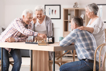 Wall Mural - Elderly people playing chess in nursing home