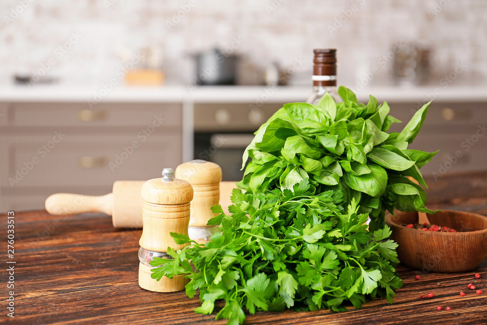 Fresh herbs with spices on table in kitchen