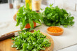 © Pixel-Shot - Cutting board with knife and fresh herbs on table in kitchen