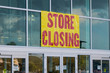 Store closing sign on business store front.