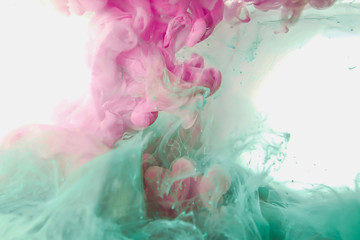 Poster - Ink paint drop in water background pink green colorful abstract texture on isolated on white background