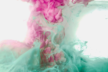 Poster - Ink paint drop in water background pink green colorful abstract texture on isolated on white background