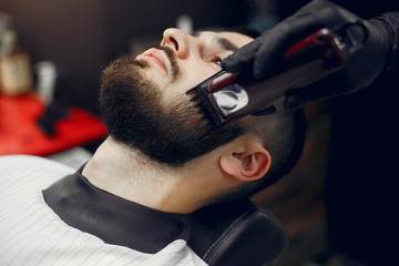 Man with a beard. Hairdresser with a client.